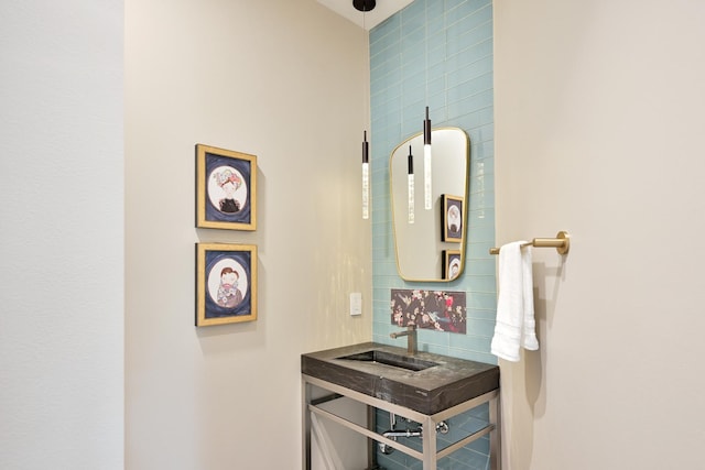 bathroom with tasteful backsplash and sink