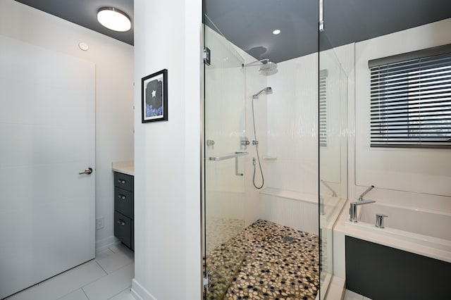 bathroom featuring vanity, independent shower and bath, and tile patterned flooring