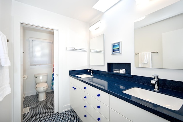 bathroom with vanity, tile patterned floors, and toilet