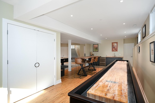 recreation room featuring light hardwood / wood-style floors and bar area