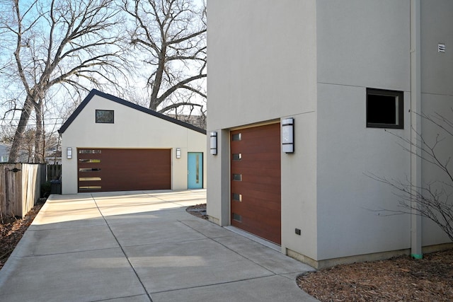 view of side of property featuring a garage and an outdoor structure