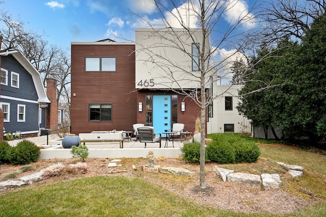 back of house featuring a yard and a patio