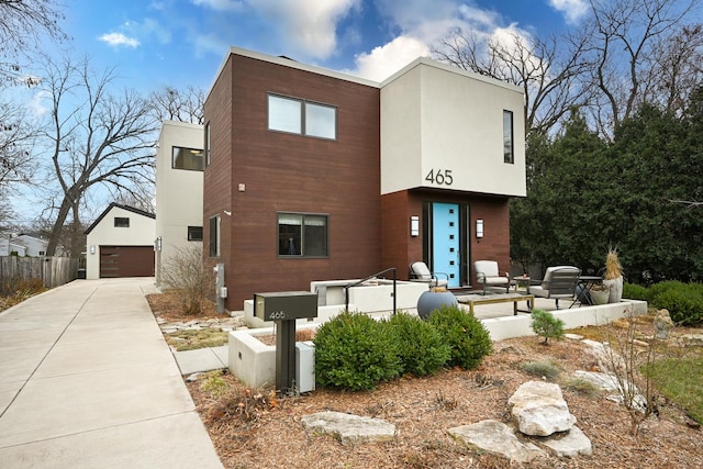 view of front facade featuring a garage and an outdoor structure