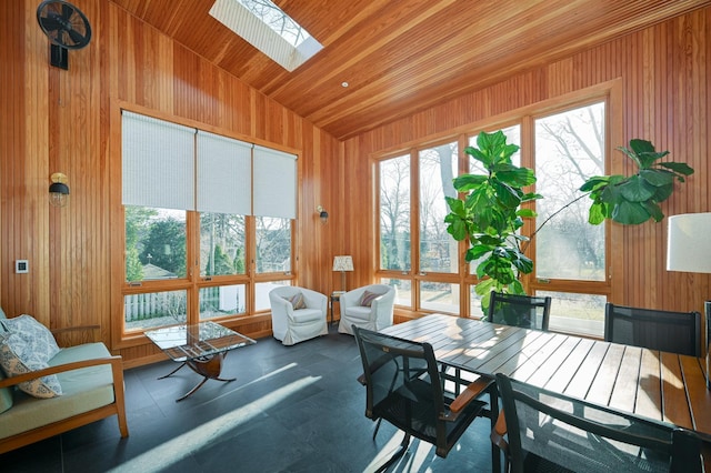 sunroom / solarium featuring vaulted ceiling with skylight and wood ceiling