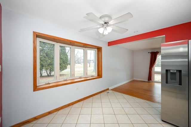 empty room featuring light tile patterned floors and ceiling fan