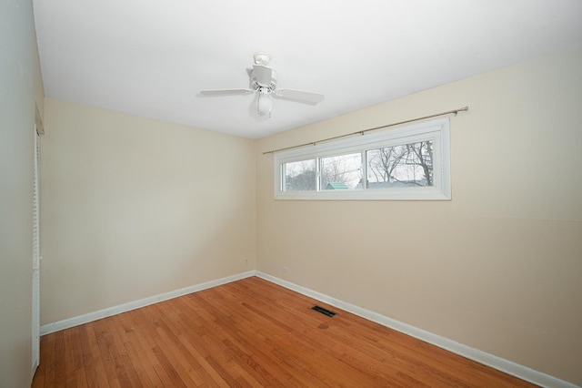 unfurnished room with ceiling fan and hardwood / wood-style floors