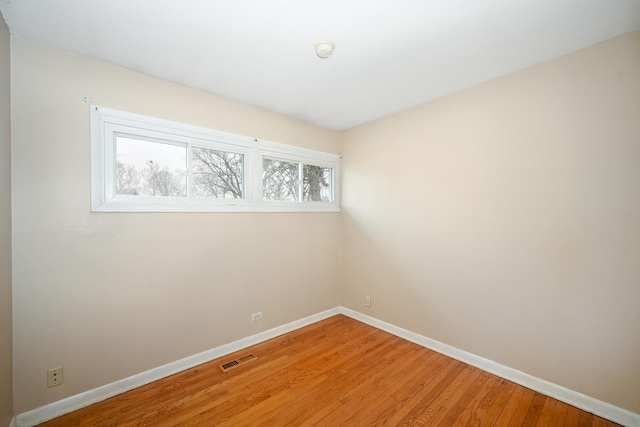 empty room with wood-type flooring