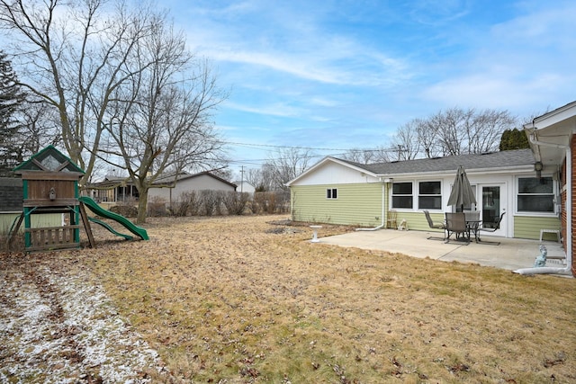 view of yard featuring a playground and a patio