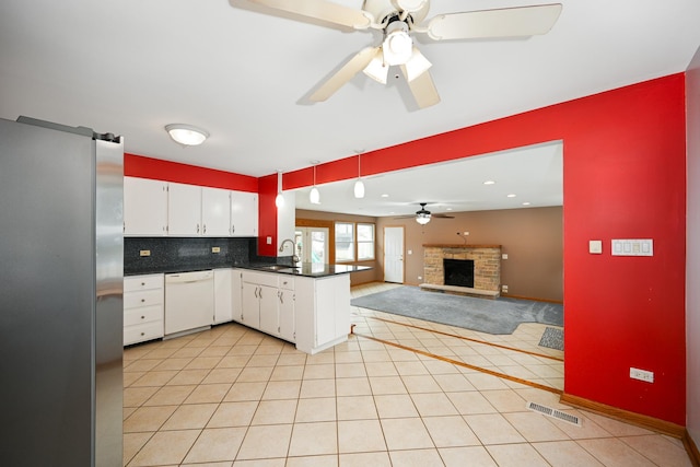 kitchen featuring sink, stainless steel fridge, white cabinetry, white dishwasher, and kitchen peninsula