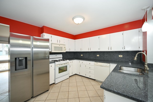 kitchen featuring sink, white cabinetry, tasteful backsplash, light tile patterned floors, and white appliances