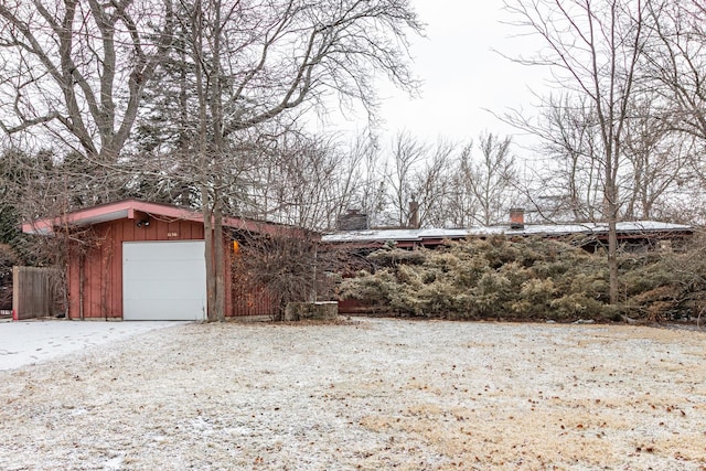 exterior space featuring a garage and an outdoor structure