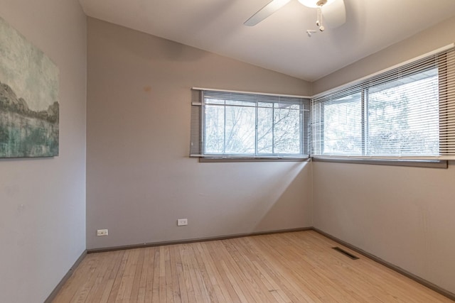 spare room featuring lofted ceiling, ceiling fan, and light hardwood / wood-style flooring