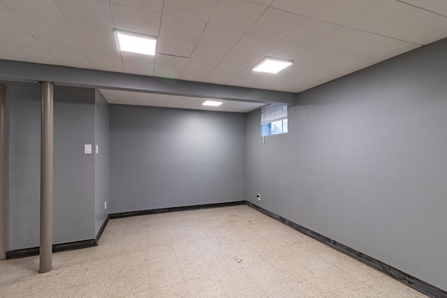 basement featuring a drop ceiling