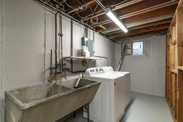 washroom featuring electric panel, sink, and washer and dryer