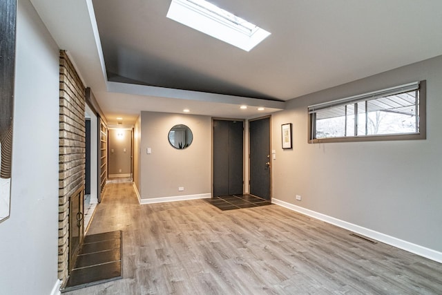 basement with light hardwood / wood-style floors