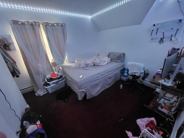 bedroom featuring vaulted ceiling, carpet, and a baseboard heating unit