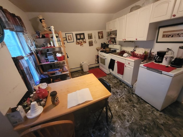 kitchen with white cabinetry, fridge, baseboard heating, and white gas stove