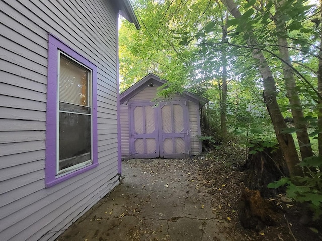 view of side of home featuring a storage unit