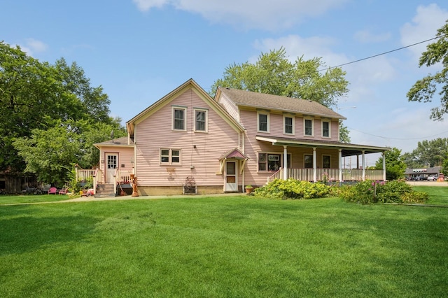 rear view of house featuring a yard and a porch