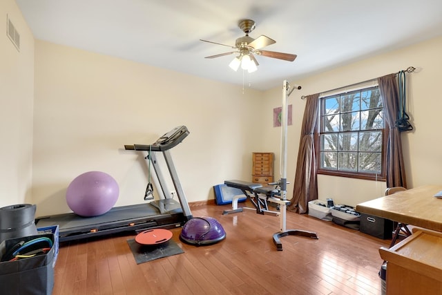 workout room featuring wood-type flooring and ceiling fan