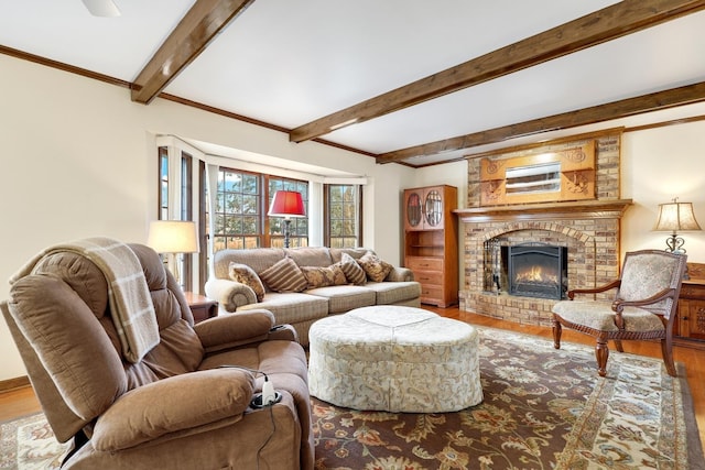 living room featuring hardwood / wood-style flooring, crown molding, a brick fireplace, and beamed ceiling