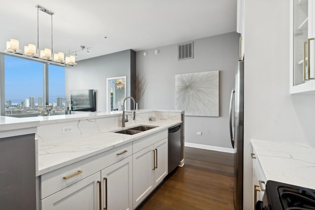 kitchen with appliances with stainless steel finishes, sink, white cabinets, and decorative light fixtures