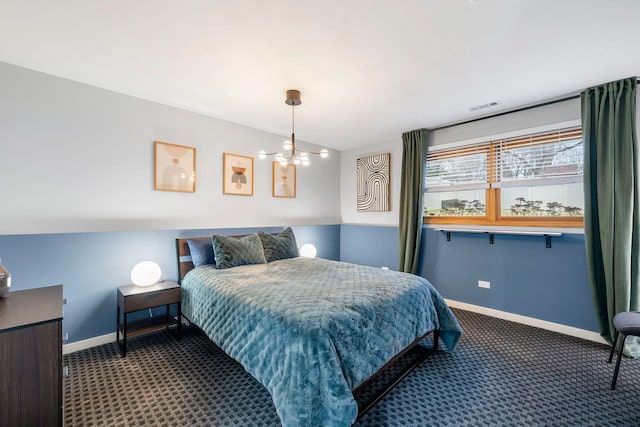 carpeted bedroom featuring a notable chandelier