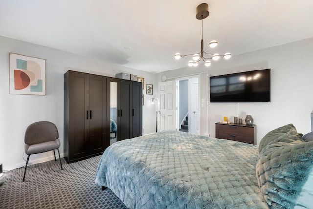 carpeted bedroom featuring a notable chandelier