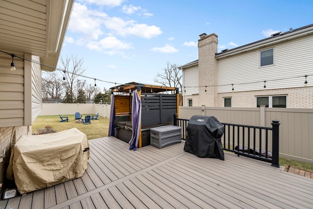 deck with area for grilling and a lawn