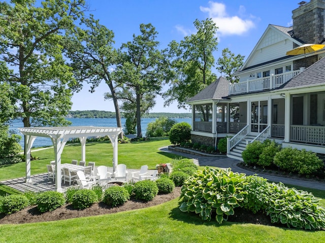 view of yard featuring a pergola, a water view, a patio area, a sunroom, and a balcony