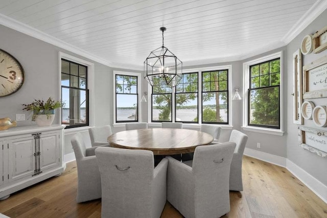 dining room with crown molding, a wealth of natural light, a chandelier, and light wood-type flooring