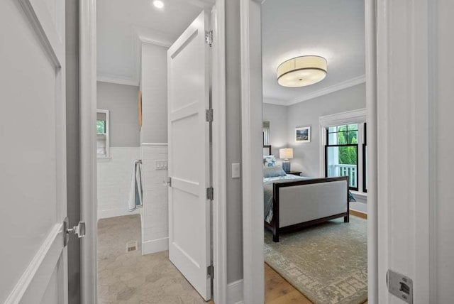 interior space featuring crown molding and tile walls