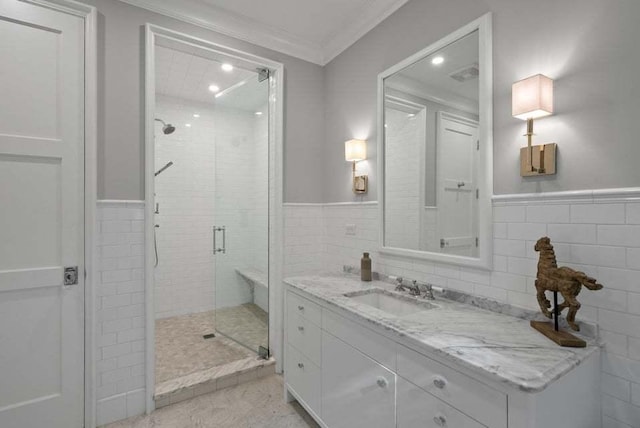 bathroom with tile walls, vanity, ornamental molding, and an enclosed shower