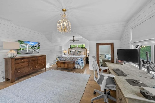 bedroom with lofted ceiling, light wood-type flooring, and wood walls