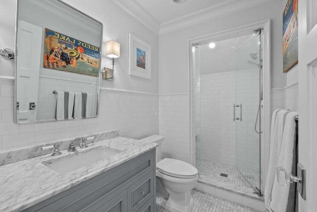 bathroom featuring crown molding, tile walls, vanity, a shower with shower door, and toilet