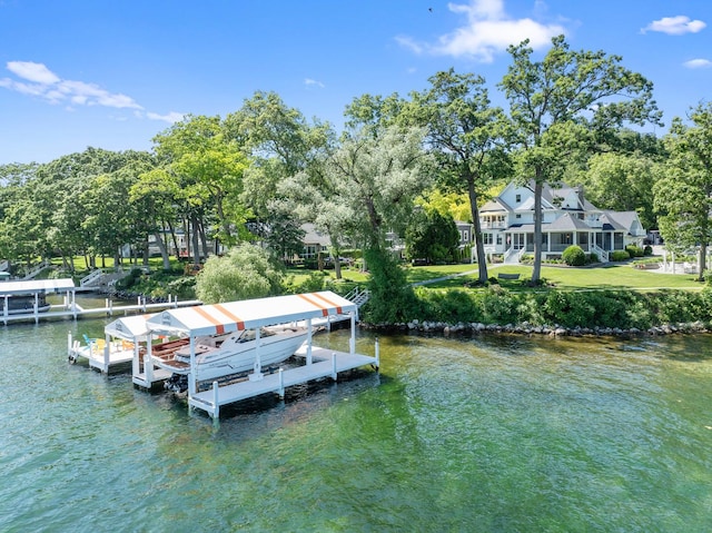 dock area with a water view and a yard