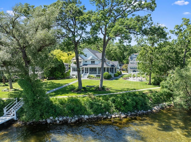 exterior space featuring a yard and a water view