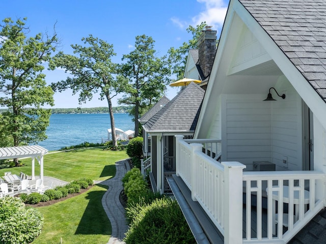 view of side of property featuring a yard and a water view