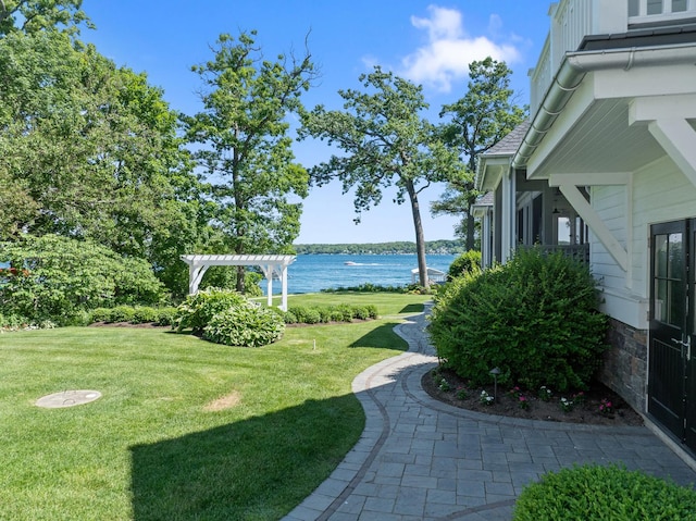 view of yard featuring a water view and a pergola