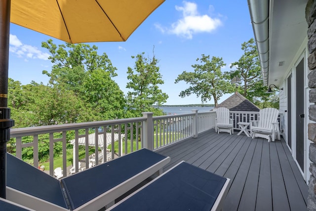 wooden deck featuring a water view