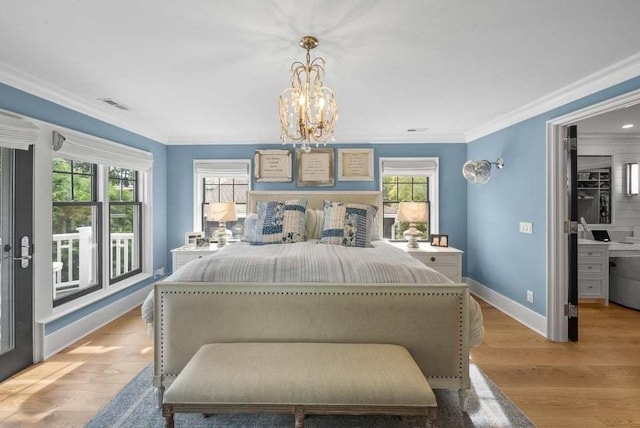 bedroom with a notable chandelier, ornamental molding, and light hardwood / wood-style floors