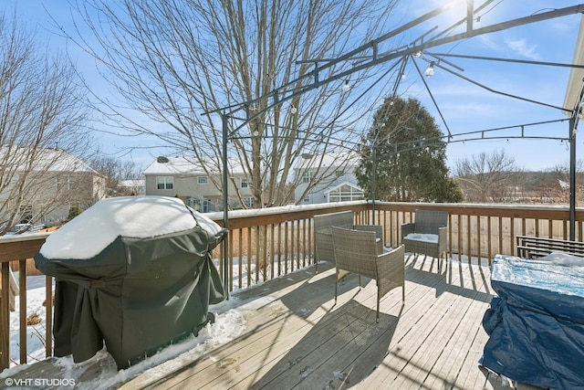 snow covered deck featuring area for grilling