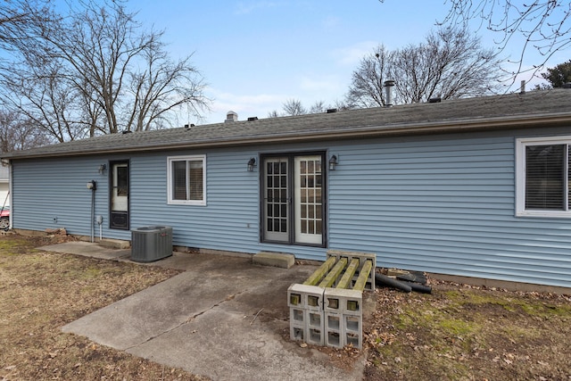 rear view of property with central AC and a patio