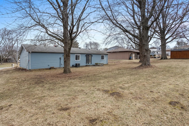 view of front of property featuring central AC and a front yard