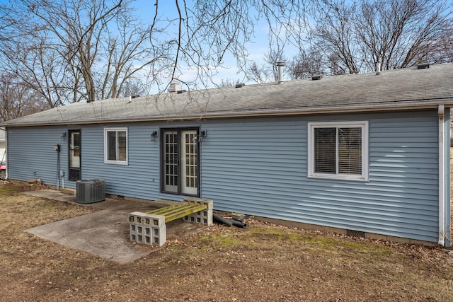 rear view of house featuring a shingled roof, crawl space, and central AC