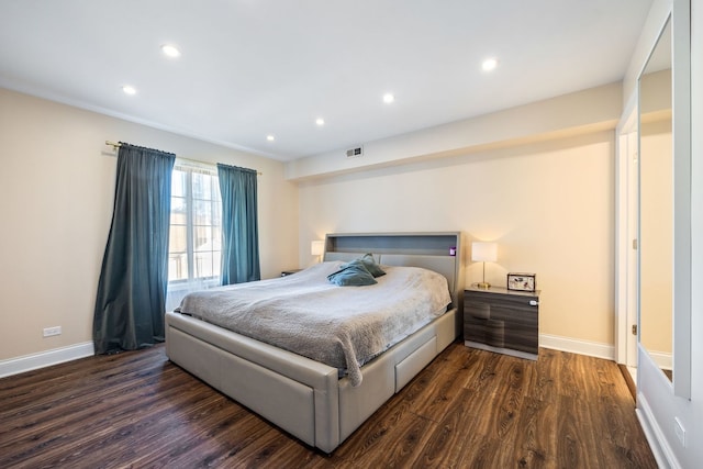 bedroom with dark hardwood / wood-style flooring