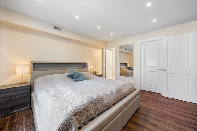 bedroom with dark wood-type flooring