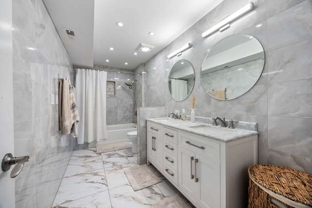 full bathroom featuring tile walls, shower / tub combo, vanity, and toilet