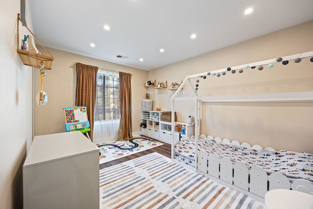 bedroom with hardwood / wood-style flooring