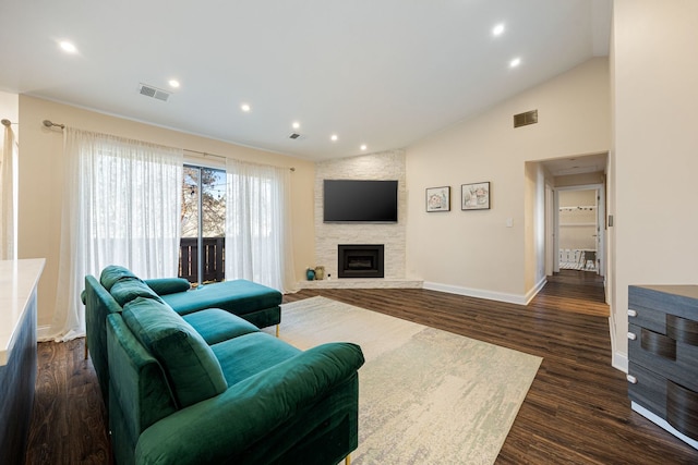 living room featuring dark hardwood / wood-style flooring, high vaulted ceiling, and a fireplace